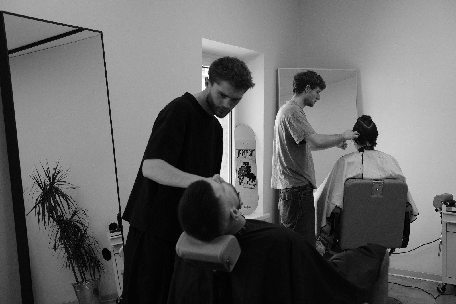 Two barbers working in the studio