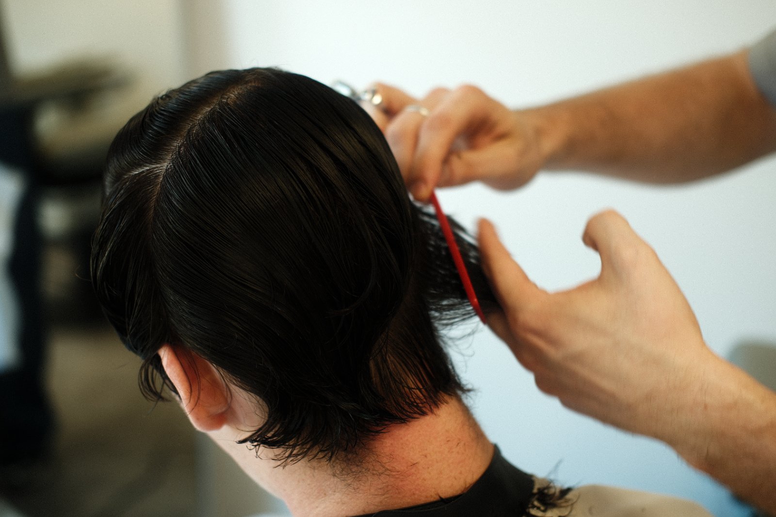 Cutting wet hair with a red comb